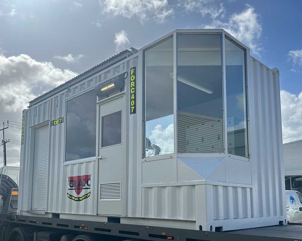 Shipping container conversion into a custom drill shack for on-site drilling.
